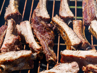 Roasted Juicy spare ribs cooked over the coals on a barbecue. Summer and holiday time. Delicious food