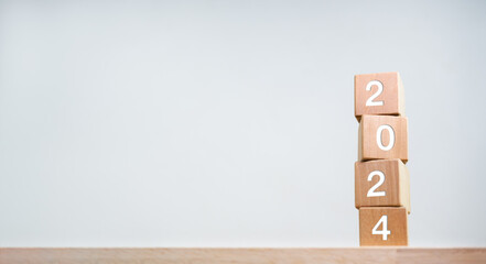 2024 Happy New year background banner. Two thousand Twenty-Three year numbers on wooden cube blocks...