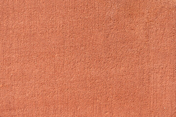 Colorful concrete wall, salmon color, plaster with small texture details