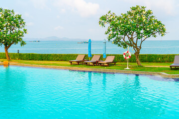 chair pool and umbrella around swimming pool