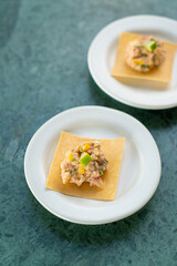 salmon with fruits salad sauce on cracker