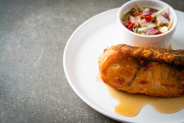 fried snapper fish with fish sauce and spicy salad