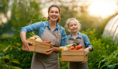 mother and daughter gardening in the backyard