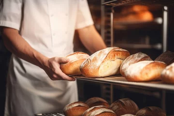 Gordijnen Hands of a professional chef with a tray of freshly baked bread © Veniamin Kraskov