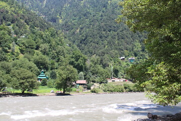 Beautiful day time view of Keran Valley, Neelam Valley, Kashmir. Green valleys, high mountains and trees are visible.