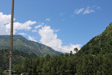 Beautiful day time view of Keran Valley, Neelam Valley, Kashmir. Green valleys, high mountains and trees are visible.