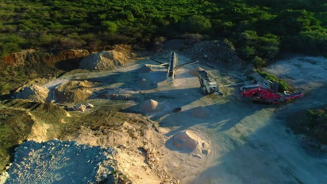 Tilt down from tall pile of fill, linear overpile portal reclaiming dirt machine and excavators