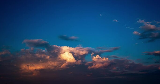 Time lapse clip of fluffy curly rolling storm clouds in windy weather in the evening