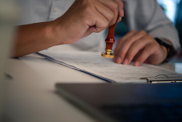 Hand man stamping documents notary public in office . Businessperson stamping approval of work...