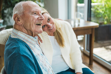 Smiling woman spending time with father at home