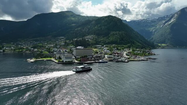 Express catamaran arriving in Epic village of Balestrand in the Sognefjord Norway - Summer panoramic aerial view