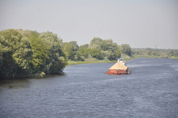 Pusher tug with a barge on the Pripyat River, Belarus.