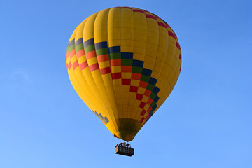 Hot air balloon is flying in the blue sky