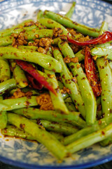 Close up dish of stir fry green bush beans with minced pork