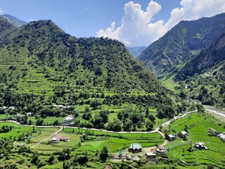Fototapeta na wymiar Beautiful day time view of Keran Valley, Neelam Valley, Kashmir. Green valleys, high mountains and trees are visible.