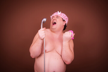 Funny man in make-up after a shower. A fat guy sings, takes pictures and has fun.