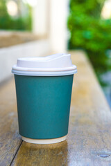 Paper Cup on Top of Outdoor Wooden Table