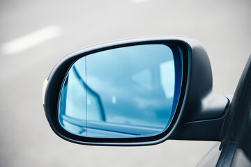 Black wing mirror of modern car. Left side car rear-view mirror.