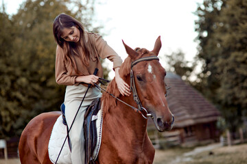 Fototapeta premium A woman is gently stroking a horse. Explore riding lessons at horse school, embrace horse therapy, and connect with animals for stress relief. Indulge in a nature weekend with emotional rewards.