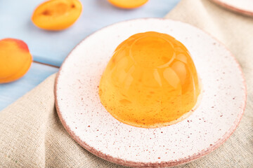 Apricot orange jelly on blue. side view, selective focus.