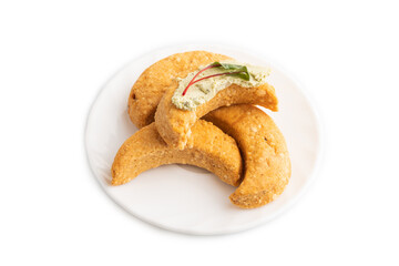 Homemade salted crescent-shaped cheese cookies isolated on white. top view.