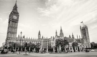 LONDON, UK - JULY 1ST, 2015: Tourists and locals walk in front of Westminster Palace.