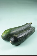 Fresh Zucchini on Green Background.