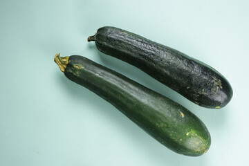 Fresh Zucchini on Green Background.