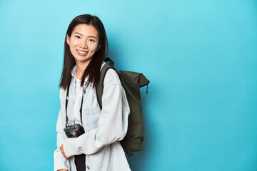 Young Asian traveler ready to capture adventures, laughing and having fun.