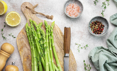 Bunch of raw asparagus stems with different spices