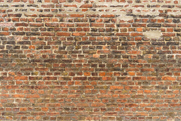 Old red brick wall with different shades. Texture of a brick wall