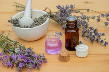 Obraz na płótnie Canvas lavender essential oil, on a wooden background. Selective focus.