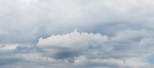 White cloud in the sky covered with dense gray clouds
