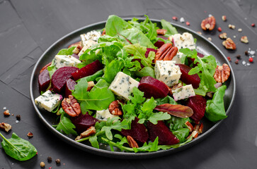 Beetroot Salad with Blue Cheese, Nuts and Salad Mix over Dark Background