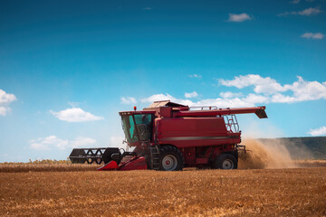 Combine harvester machine working in a wheat field