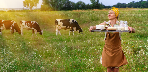 Dairy products on a cow farm are held by a woman in her hands. Selective focus.
