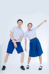 Asian girl and boy in student's uniform on white background. Thai students.