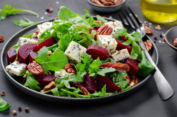 Beetroot Salad with Blue Cheese, Nuts and Salad Mix over Dark Background