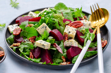 Beetroot Salad with Blue Cheese, Nuts and Salad Mix over Bright Background