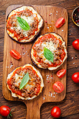 Eggplant Pizza with Tomato Sauce, Minced Meat, Mozzarella and Basil, Mini Vegetable Pizza over Wooden Background