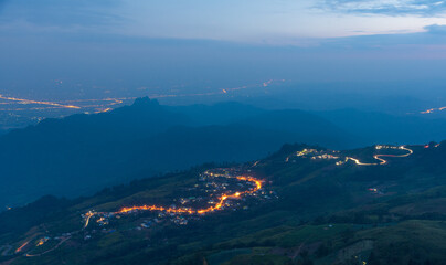 view of light streaks on the road winding up the hill at Phu Thap Boek, Thailand