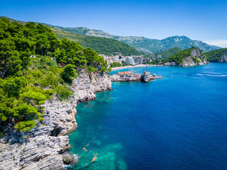 Petrovac na Moru Aerial View. Beaches and coastline of the Adriatic Sea at summer time. Natural landscapes of Montenegro. Balkans. Europe.