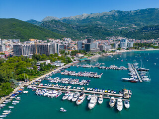 City of Budva in Montenegro. Aerial view of Port and Beach Greco. Coastline of the Adriatic Sea at summer time. Natural landscapes of Montenegro. Balkans. Europe.
