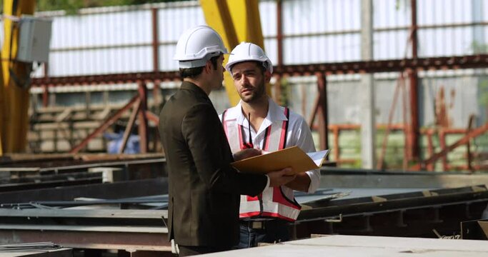 building and construction worker, Hiapanic latin male wearing safety hard hat helmet standing at Prefabricated concrete walls Industry Manufacturing Factory. Unity and teamwork