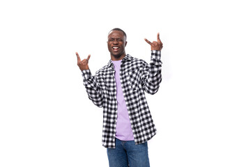 Naklejka premium handsome young american man in a plaid shirt is actively moving