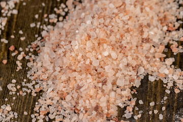 Pink natural salt on the table, close up