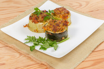 Serving of cooked stuffed zucchini on dish on place mat