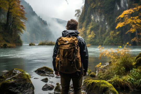 Hiker gazing at a breathtaking waterfall cascading down - stock photography concepts