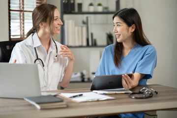 Fototapeta premium female doctor consulting with a female nurse at the clinic at the hospital