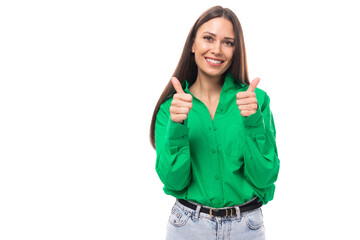 pretty young caucasian brunette lady with makeup dressed in a green shirt and jeans posing on a white background with copy space